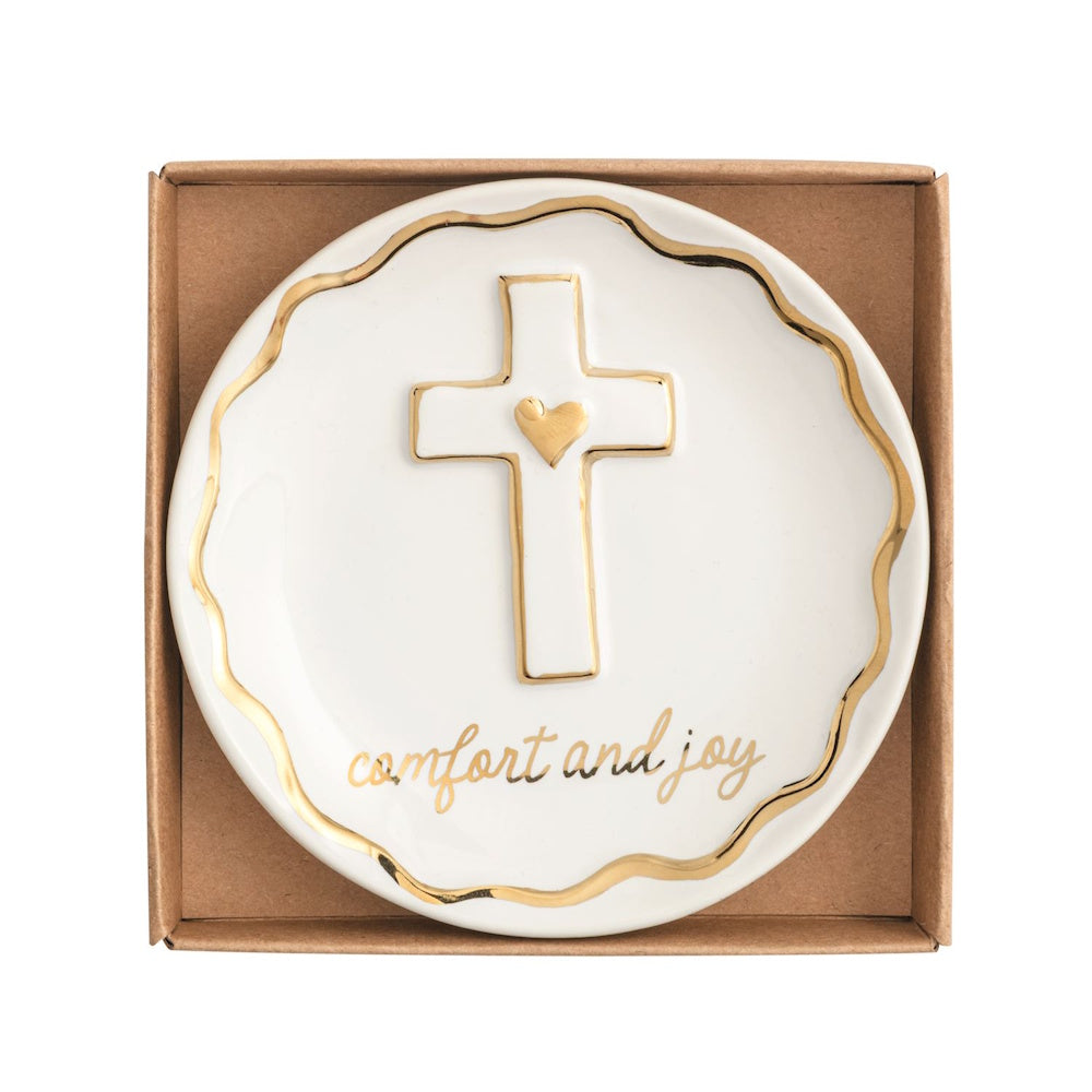 White ceramic trinket dish featuring a gold-trimmed cross, heart, scalloped edge, and "comfort and joy".