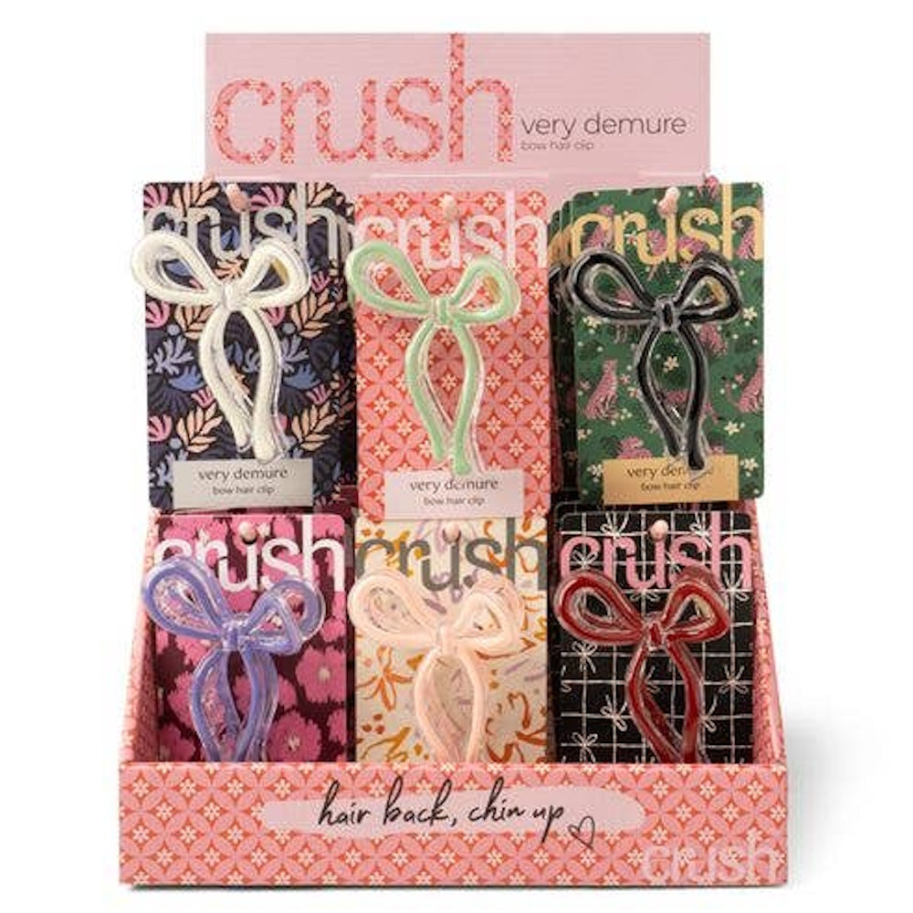 Display of Very Demure bow hair clips in various colors including mint, white, black, lavender, peach, and red.