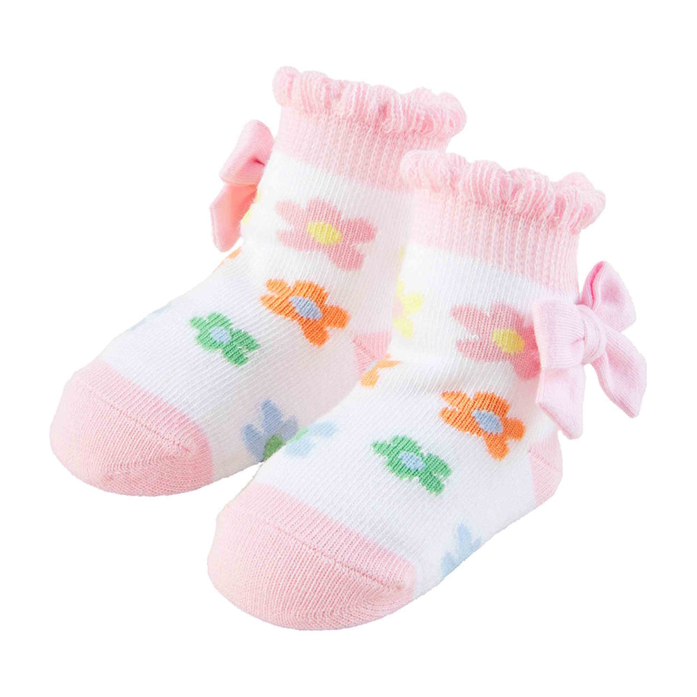 Pair of white and pink baby socks with colorful floral patterns, ruffled cuffs, and decorative pink bows on the sides.