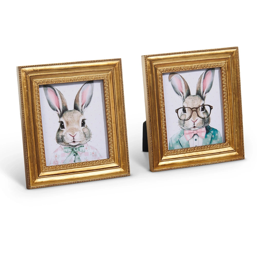 Two framed illustrations of rabbits dressed in stylish attire: one in a bow tie, the other in glasses and a suit, both with gold frames.
