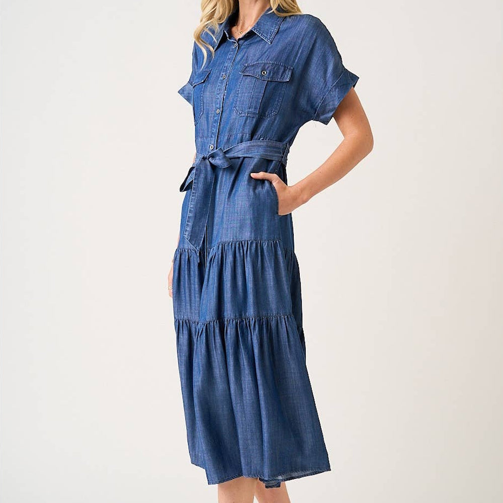 Dark denim washed Tencel chambray maxi shirt dress with a tiered skirt, belted waist, and button-down front.