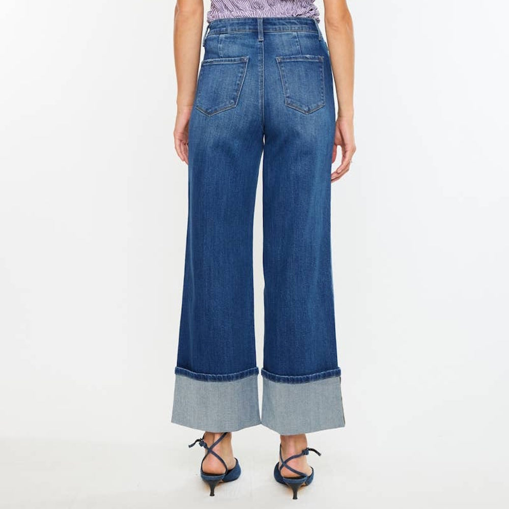 Back view of high-rise wide-leg blue jeans featuring wide cuffed hems and back pockets.
