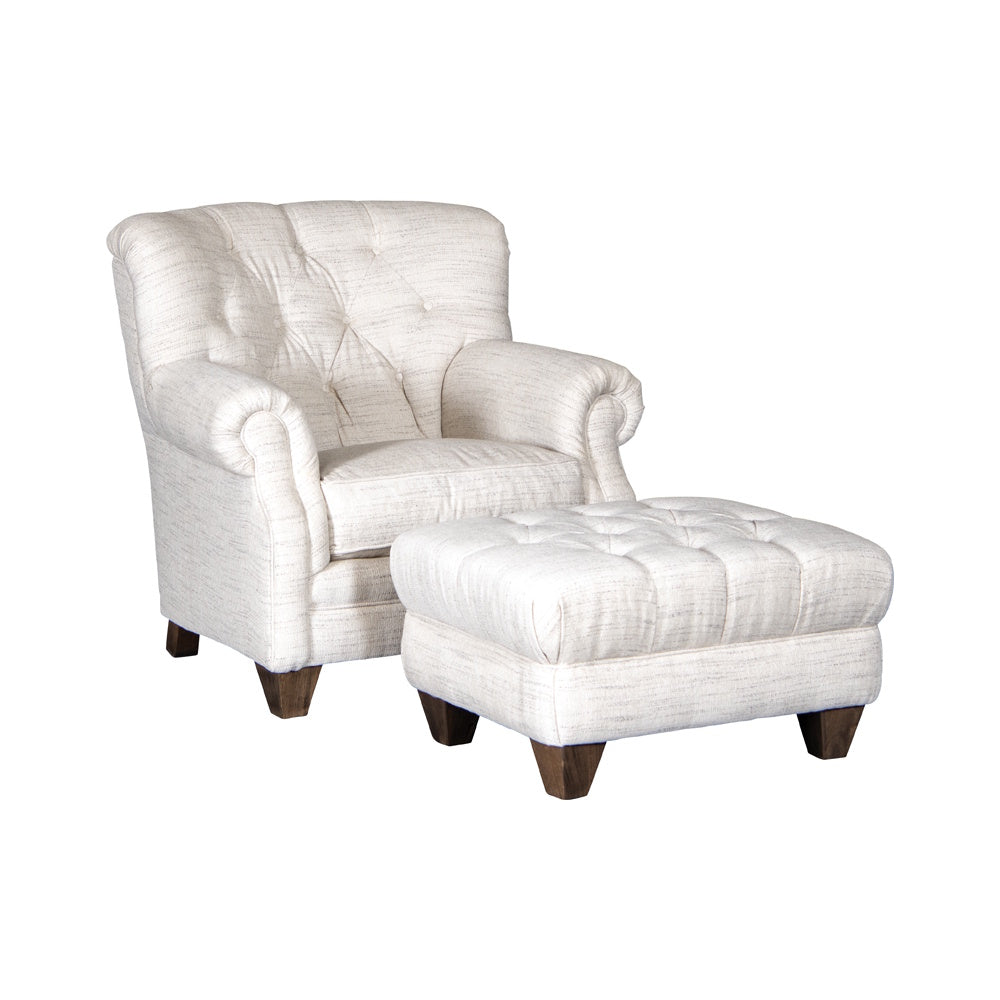 Tufted cream cotton armchair with matching ottoman and dark wood legs on a white background.