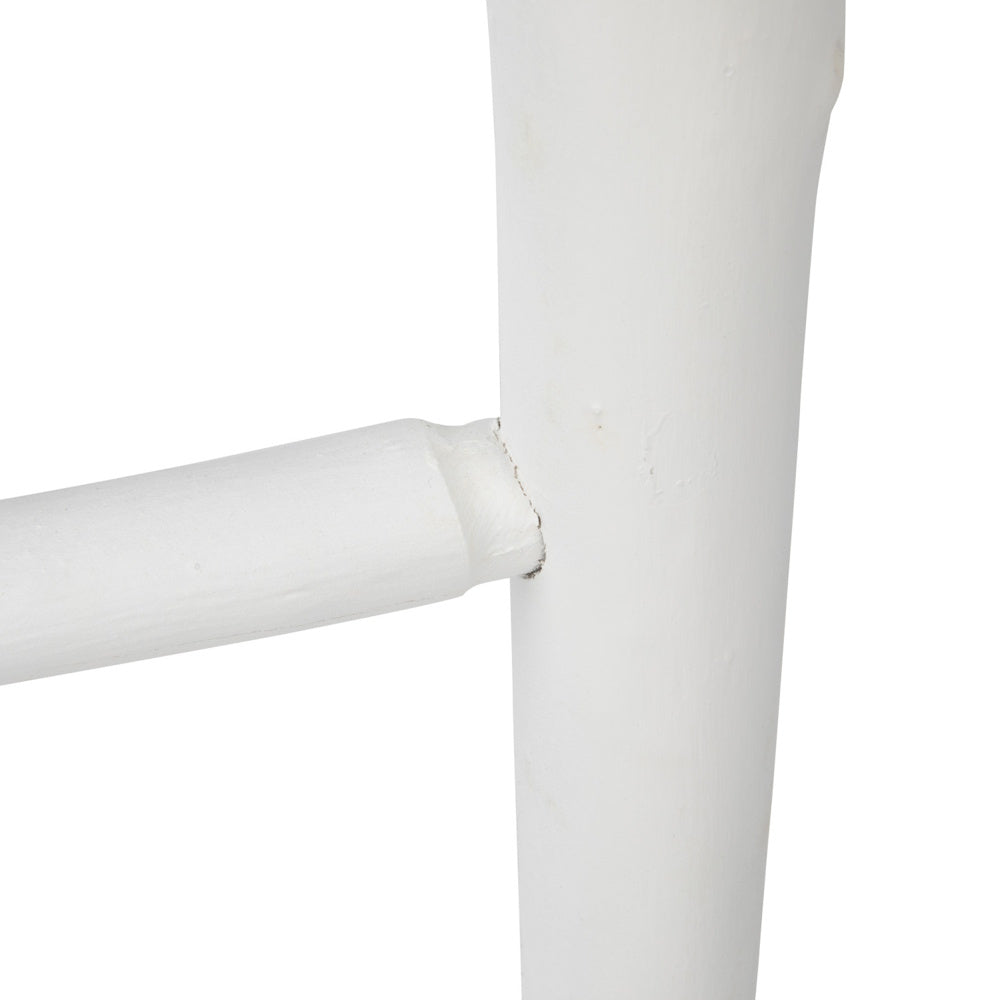 Close-up of a white painted wooden blanket ladder showing a rung joined to the main side rail.