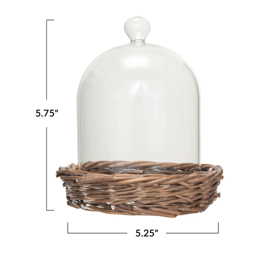 Glass dome cloche with woven willow base, measuring 5.75 inches tall by 5.25 inches wide.