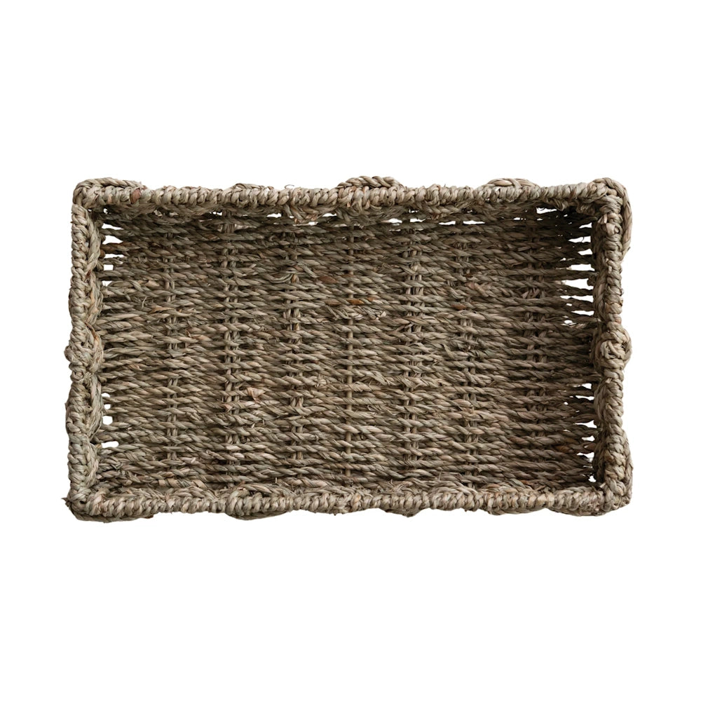 Top-down view of a rectangular hand-woven seagrass basket tray isolated on a white background.