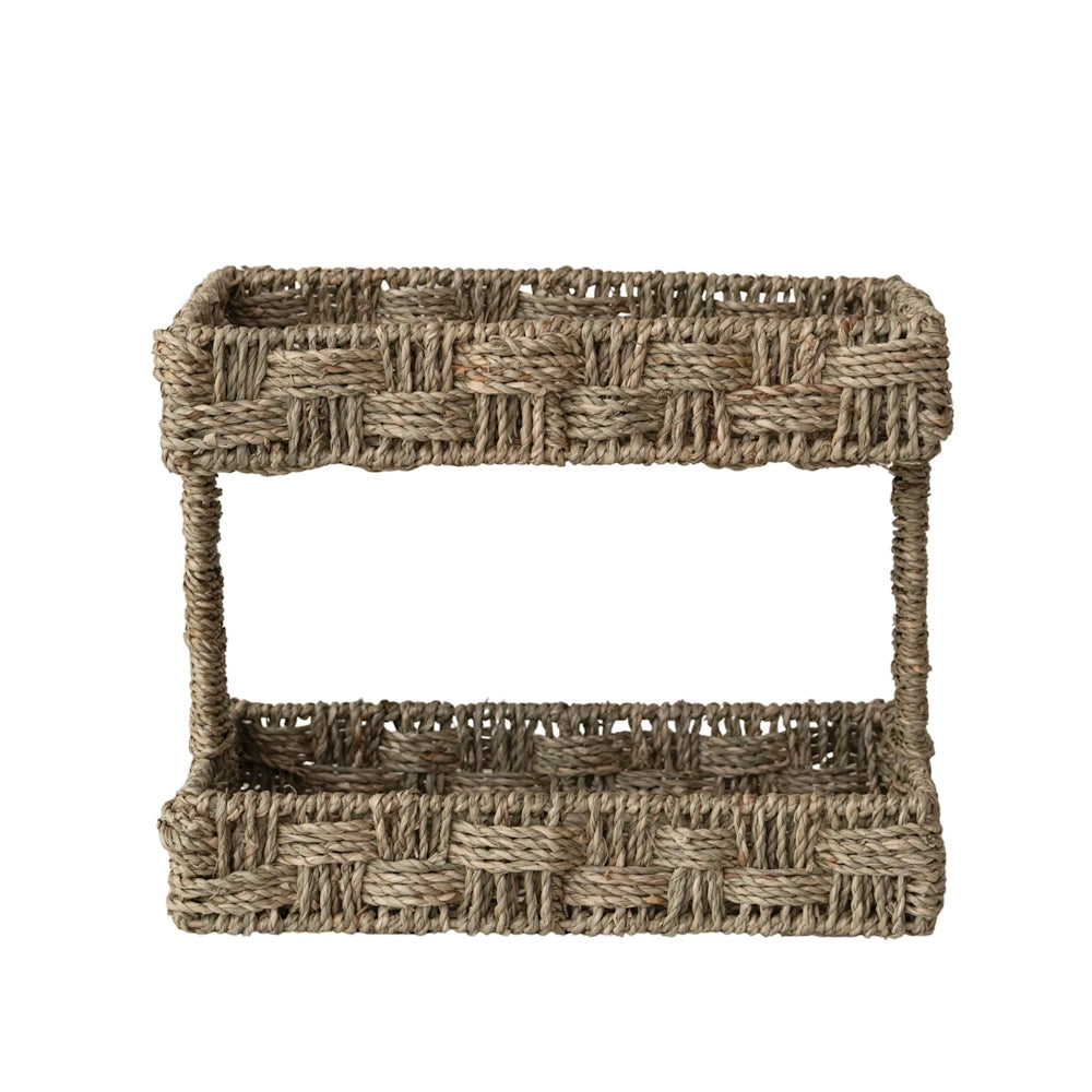 Hand-woven two-tier rectangular seagrass basket organizer on a white background.