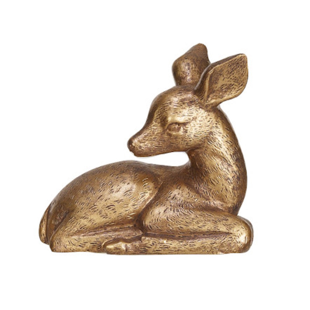 Golden bronze figurine of a resting deer fawn looking back over its shoulder.