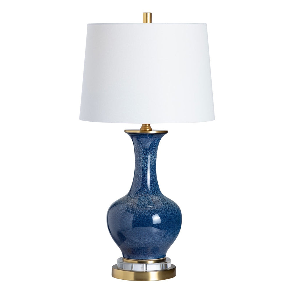 Blue ceramic table lamp with gold accents and white drum shade for modern living room decor.