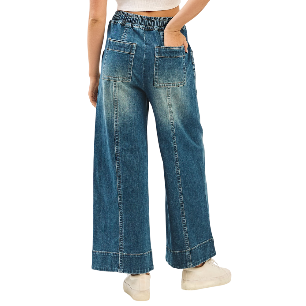 Back view of faded wide-leg denim pants with elastic drawstring waist and large patch pockets.