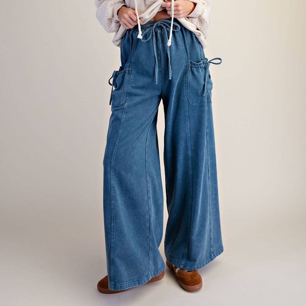 Denim blue washed terry knit wide-leg pants with drawstring waist and cargo pockets.