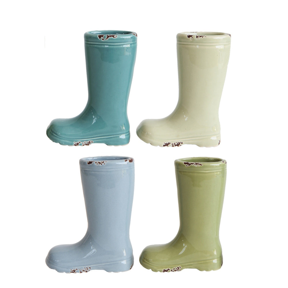 Four distressed stoneware vases shaped like rain boots, in teal, cream, light blue, and olive green colors.
