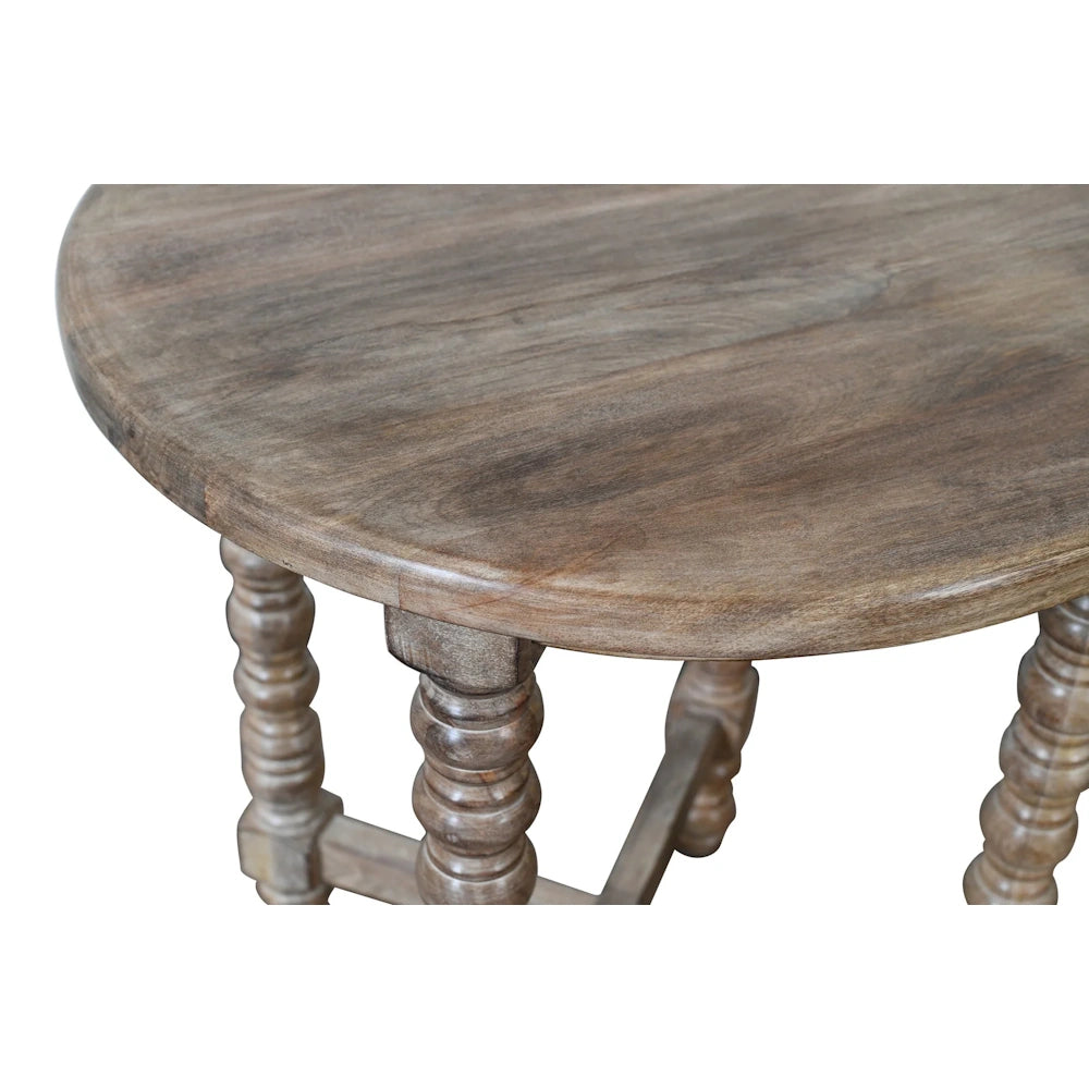 Close up of natural wood accent table with rounded tabletop edge and turned spindle leg details.