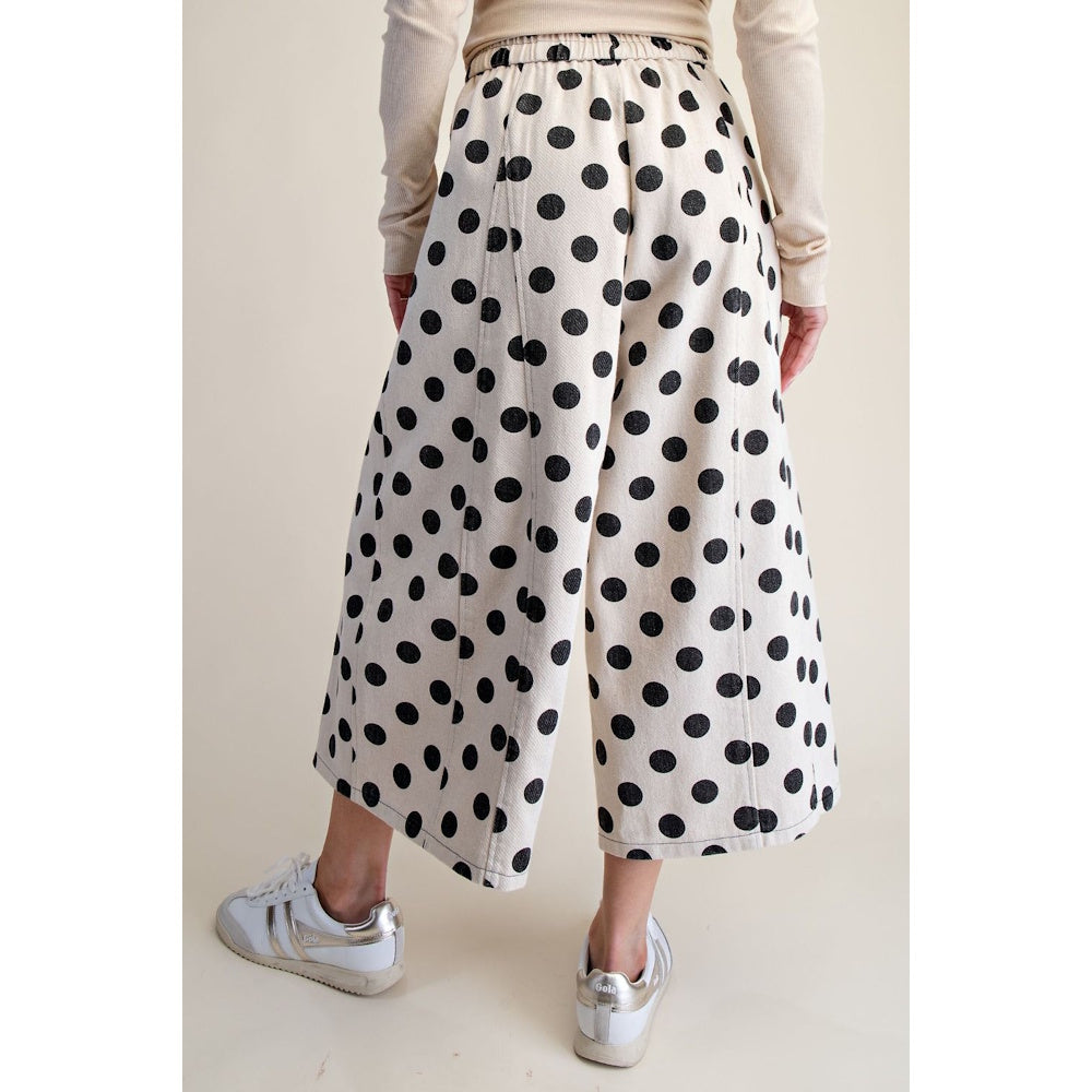 White wide-leg pants with a black polka dot print shown from the back.