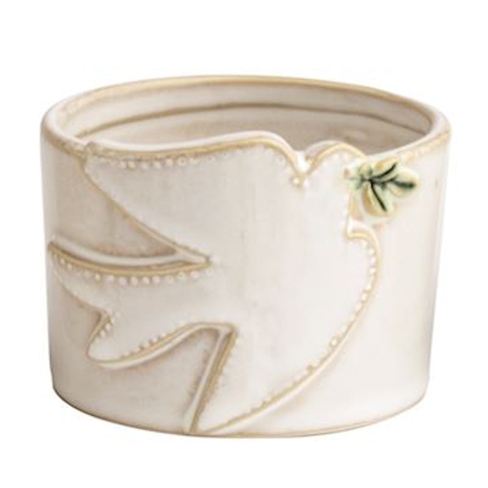 Small white ceramic dish featuring an embossed peace dove holding a green leaf.