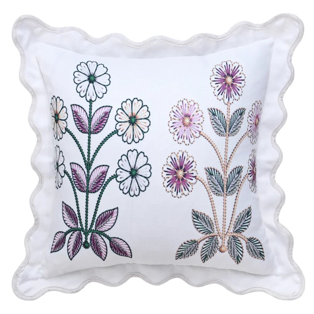 White scalloped throw pillow by Tamara Day featuring embroidered purple and green floral motifs on a down-fill cushion.
