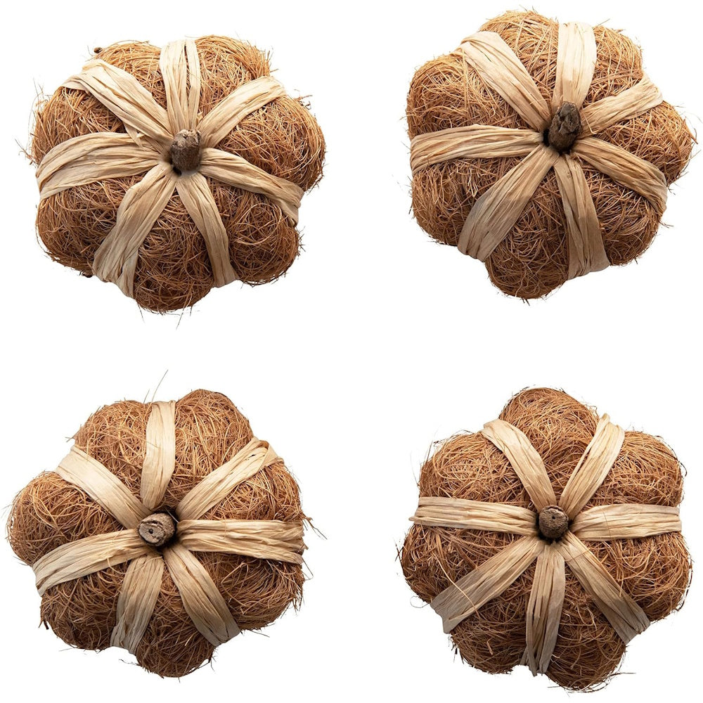 Top view of four rustic decorative pumpkins made from natural brown coco fiber and tied with beige raffia.