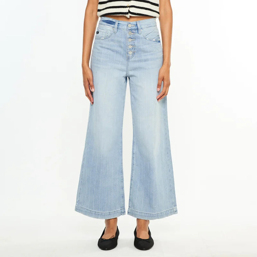 Light wash wide-leg jeans with button fly, pinstripe detail, and high-waisted fit paired with black ballet flats.