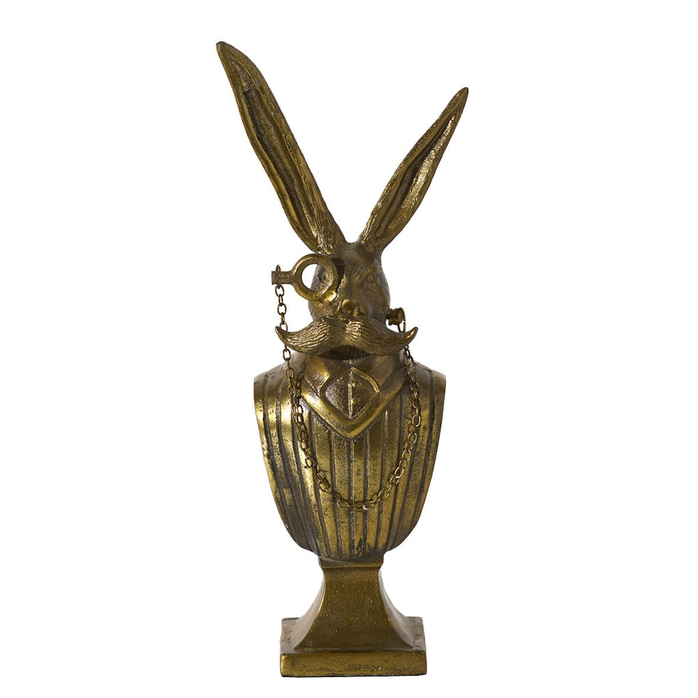 Front view of an antique gold metal rabbit bust wearing a monocle and waistcoat.