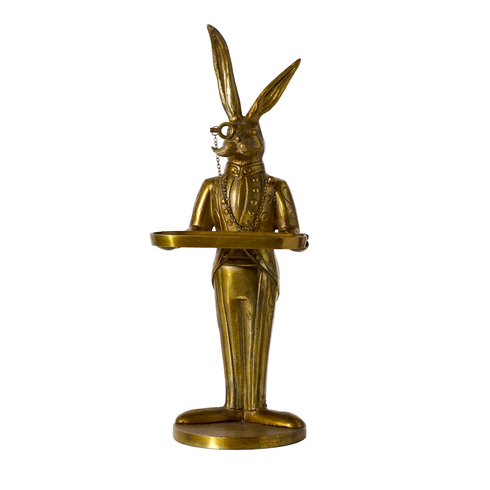 Brass rabbit butler statue wearing a suit and monocle, holding a small round serving tray.