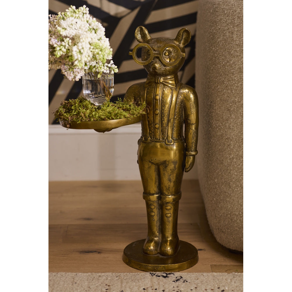 A brass cat butler statue wearing glasses and holding a tray with moss and a small flower vase.