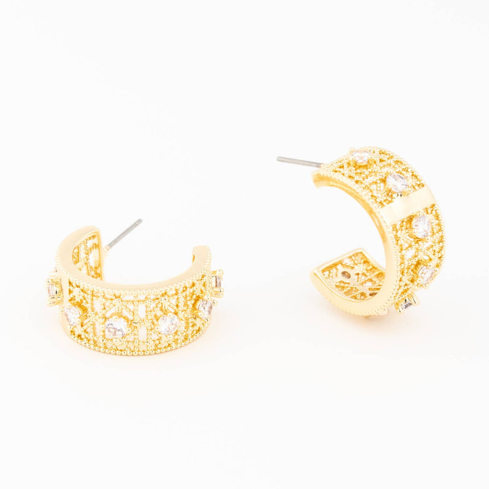 Pair of gold half-hoop earrings featuring intricate filigree details and round clear crystals.