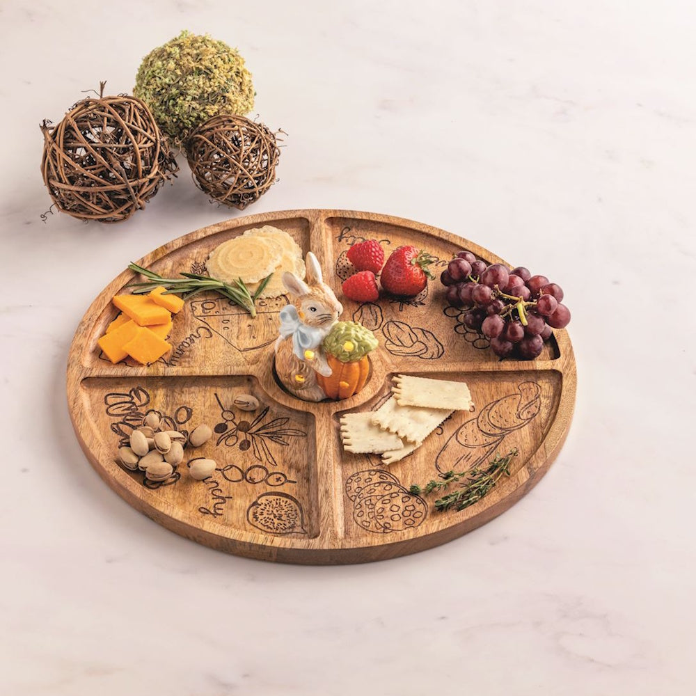 Wooden Easter bunny charcuterie board with cheese, fruit, and nuts. Features a light-up bunny sitter centerpiece.