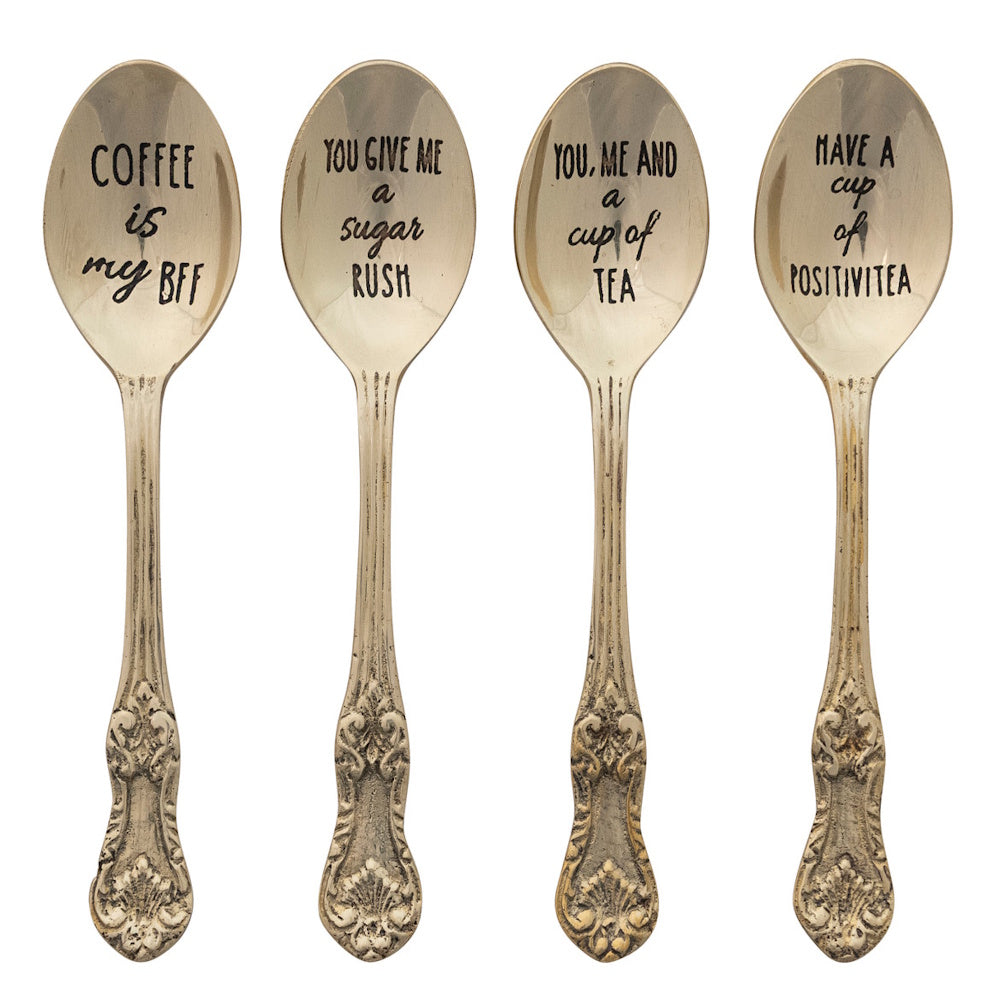 Four vintage brass spoons with etched coffee and tea quotes.
