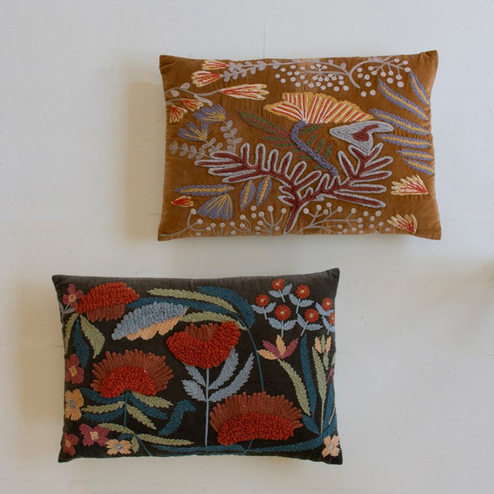 Two rectangular throw pillows in brown and dark grey with colorful embroidered floral designs.