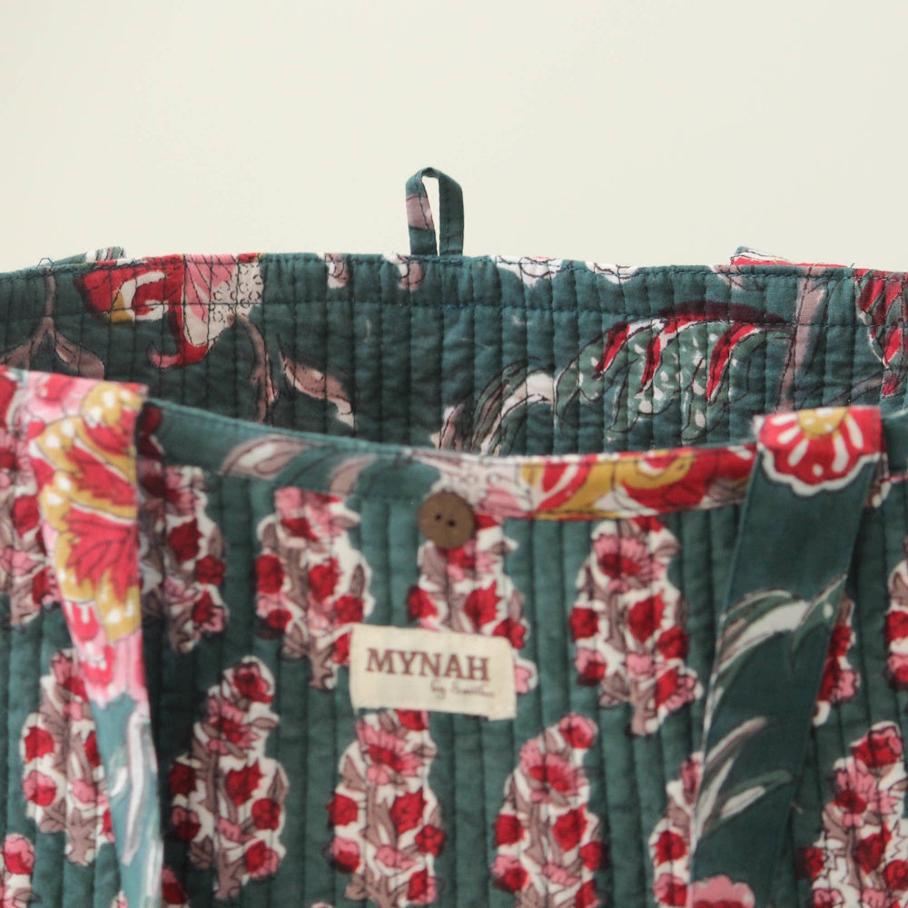 Emerald forest floral print quilted tote bag with MYNAH brand label, wooden button, and loop closure.