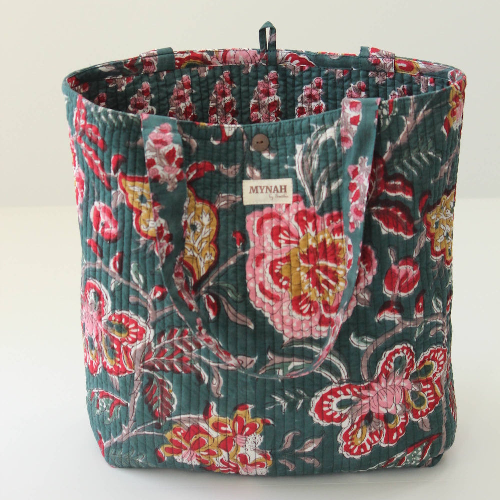 Emerald forest green quilted tote bag with a pink and yellow floral block print design and Mynah brand label.