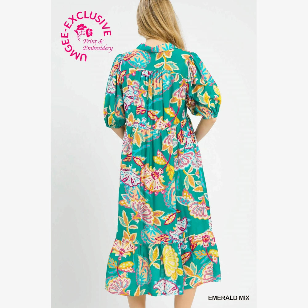 Emerald green paisley print maxi dress with a tiered skirt and multicolor floral patterns in pink, yellow, and orange.