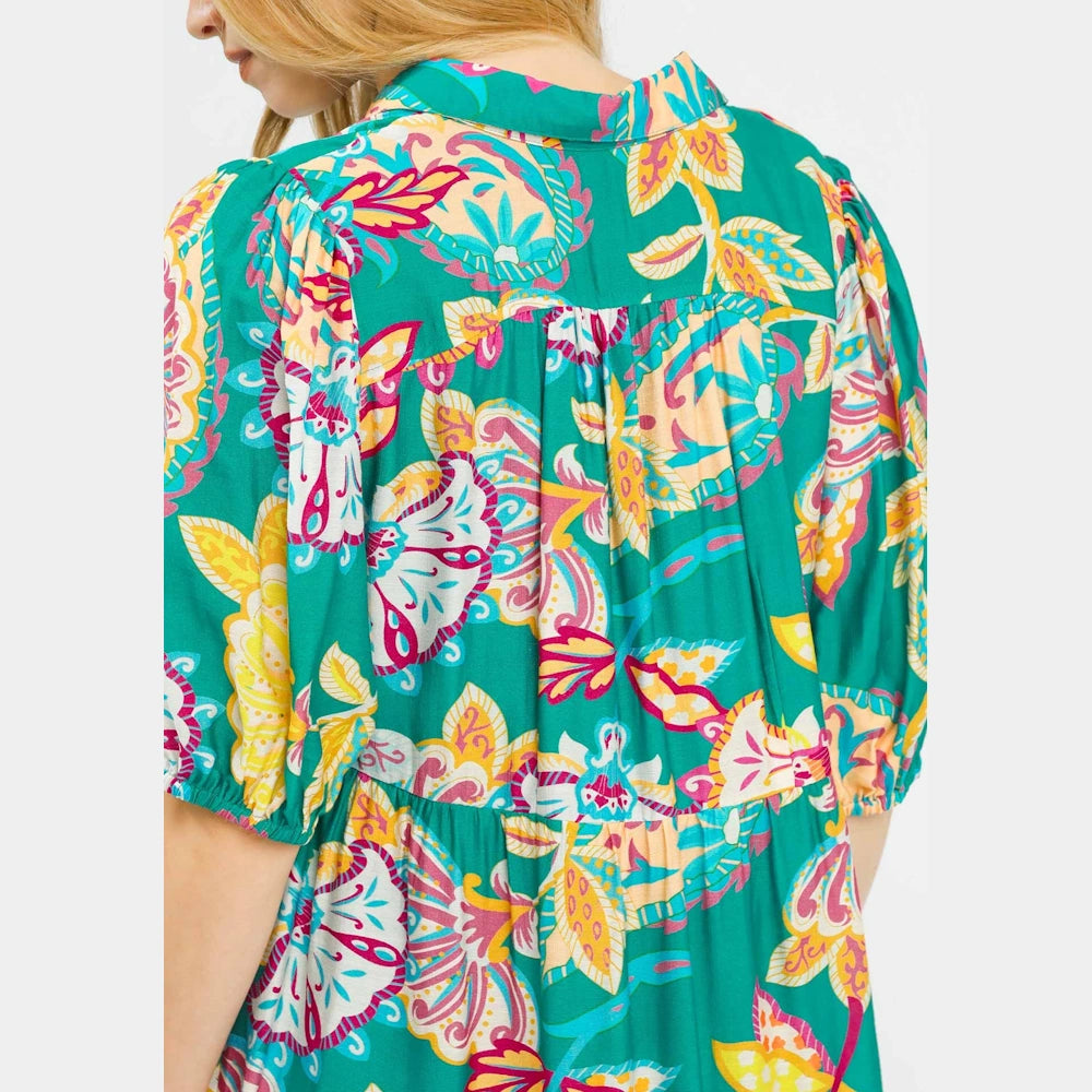 Emerald green paisley print maxi dress with tiered seams and puff sleeves, shown from the back on a model.