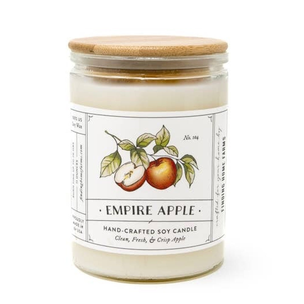 Empire Apple hand-crafted soy candle in a clear glass jar with a wooden lid and botanical label.
