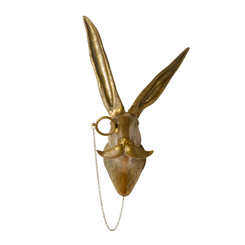 Gold hare head wall mount with long ears, a monocle on a chain, and a large handlebar mustache.