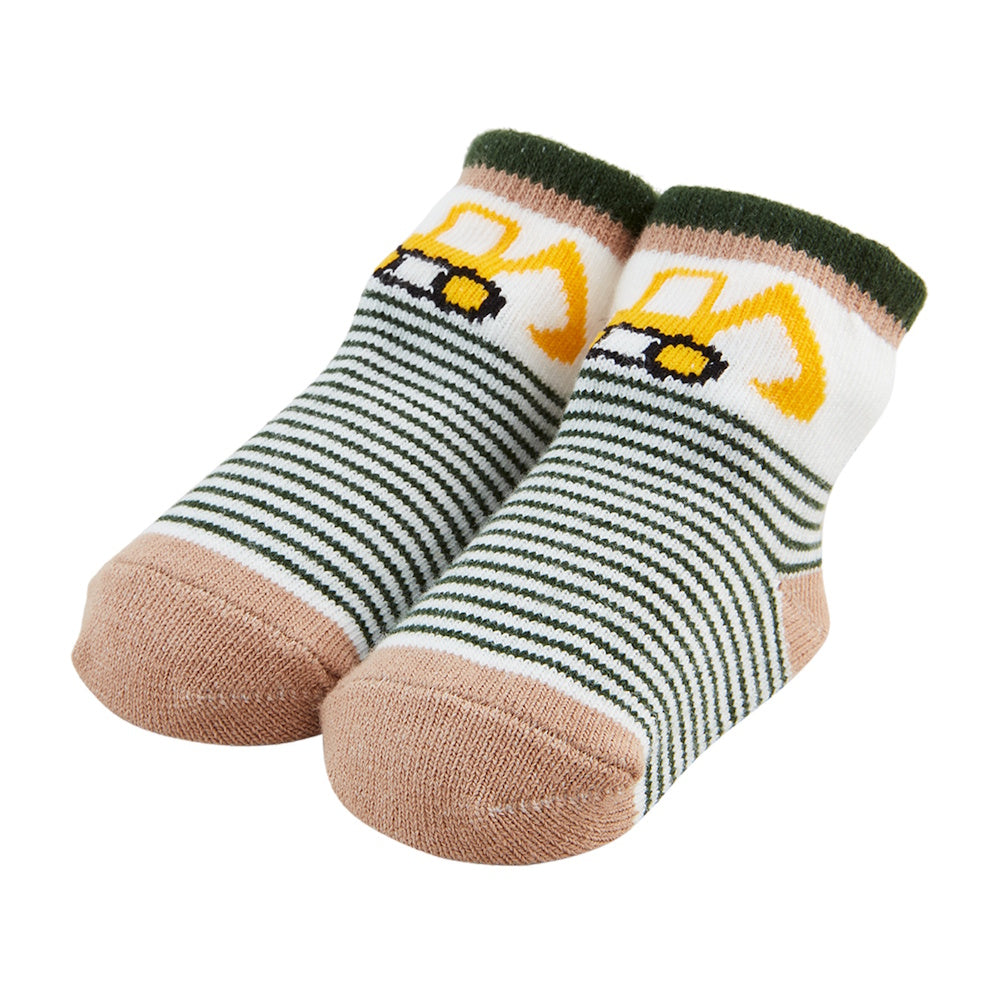 Pair of baby socks with yellow excavator graphics, green and white stripes, and tan toes and heels on a white background.