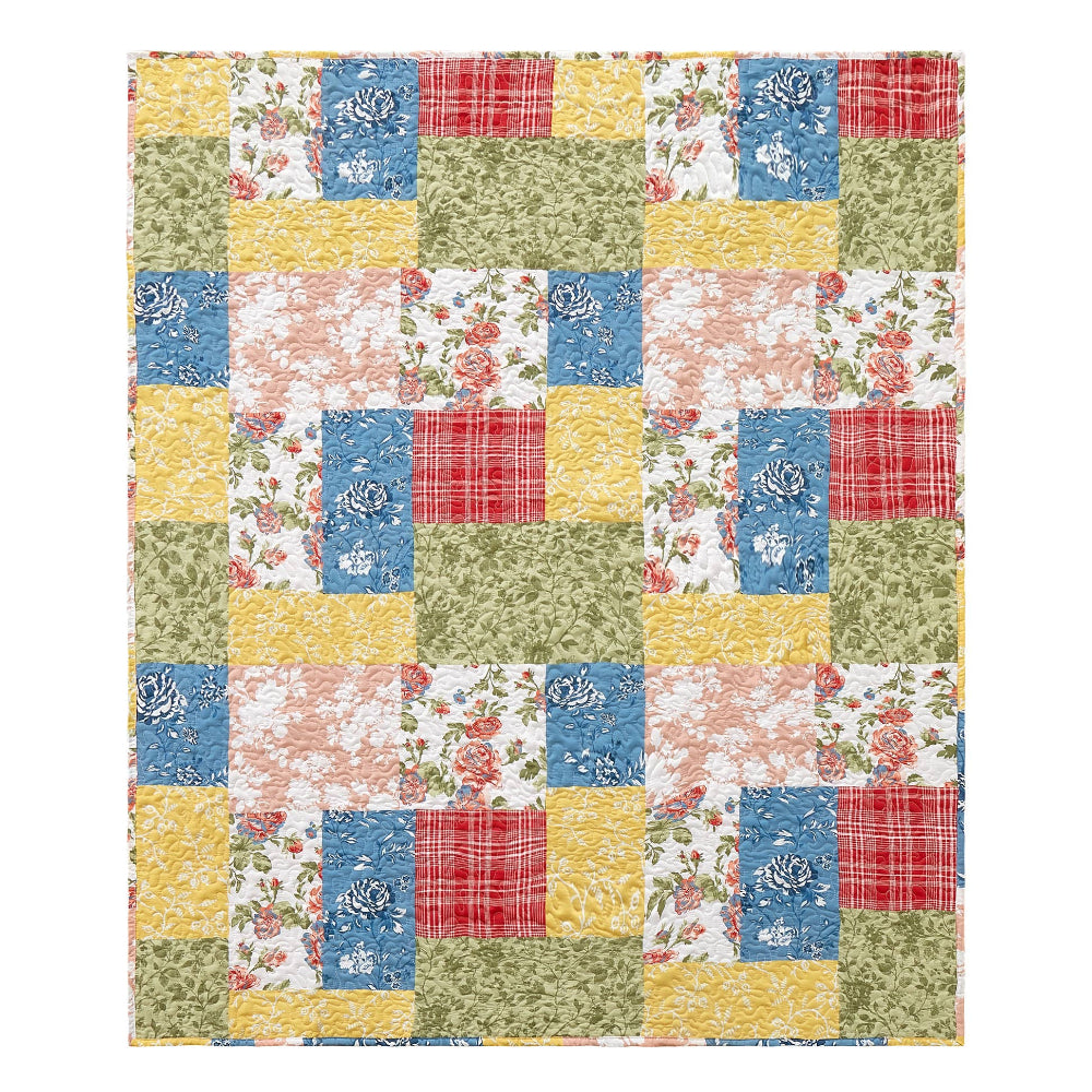 Colorful patchwork quilt throw with blue, red, and yellow floral and plaid patterns in a rustic farmhouse style.