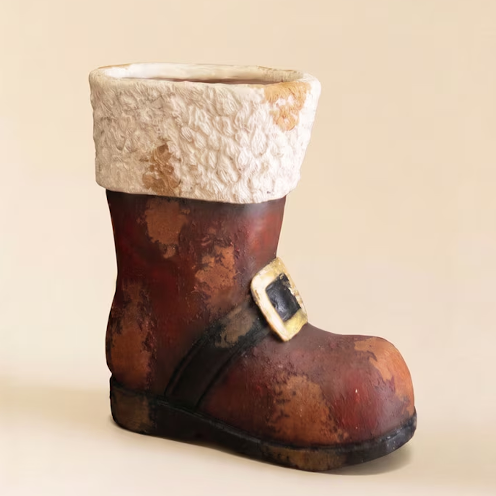 Distressed faux-concrete Santa boot decoration with white fur trim against a plain background.