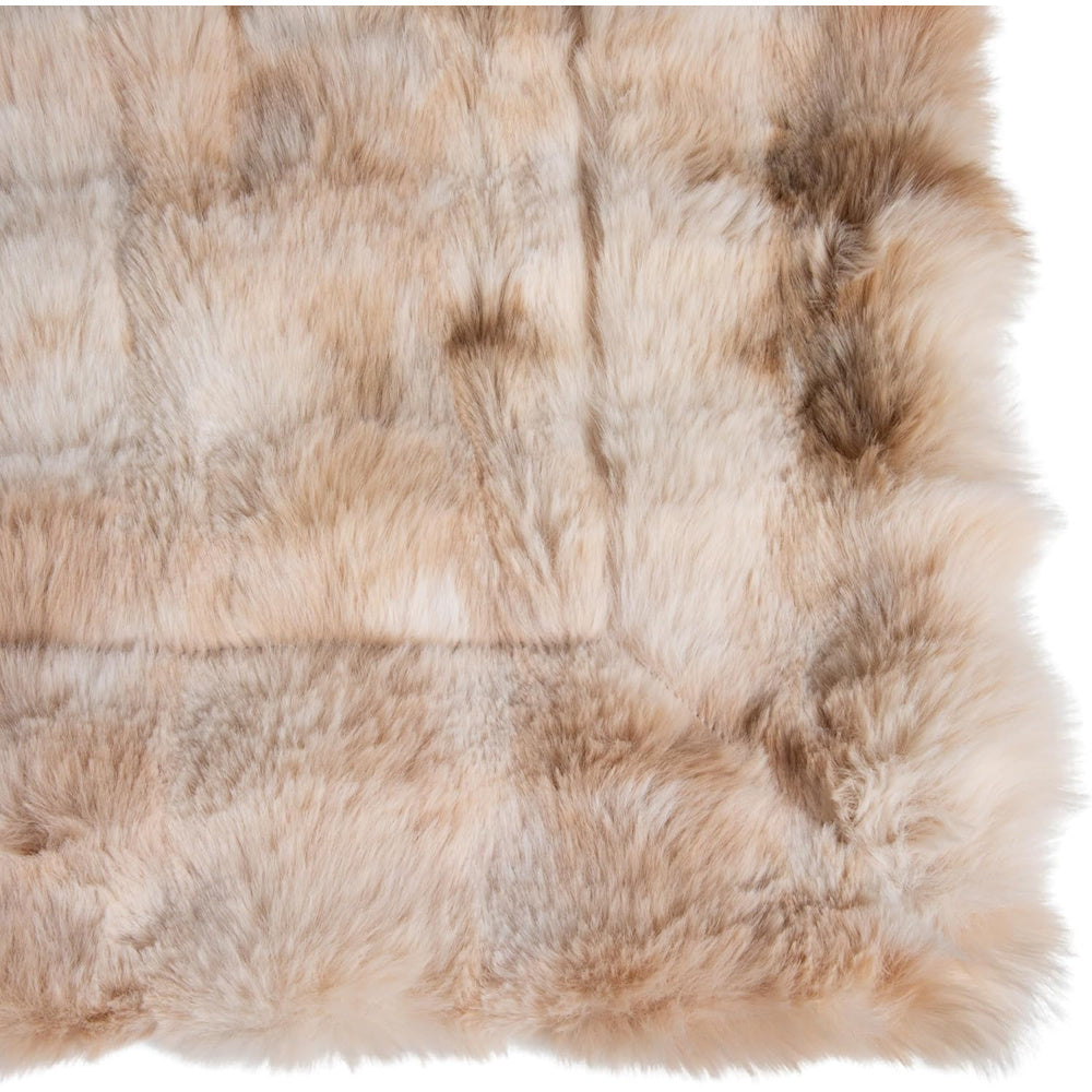 Close-up of a plush faux fur throw blanket featuring a tan and brown acid wash effect and soft, shaggy texture.