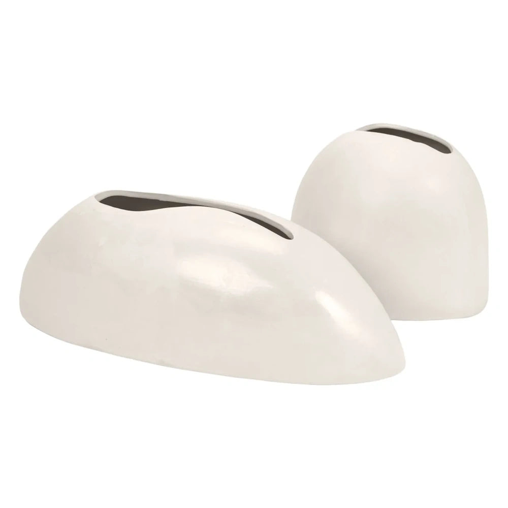 Two white, minimalist ceramic vases with smooth, rounded shapes and narrow openings on a white background.