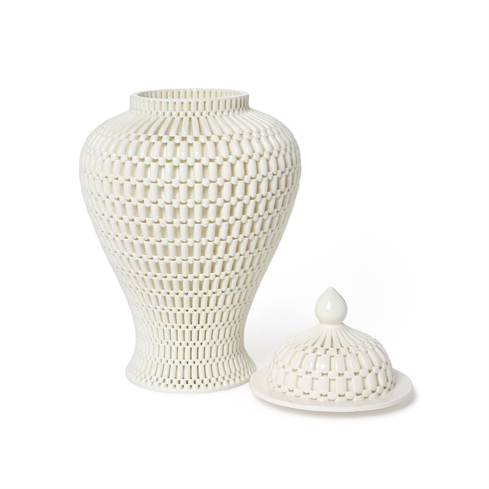 White ceramic filigree temple jar with its lid removed next to it on a plain background.