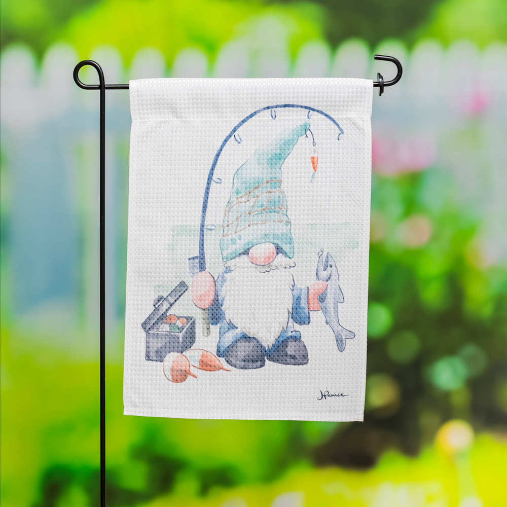 A garden flag featuring a fishing gnome holding a rod and a caught fish, next to a tackle box.