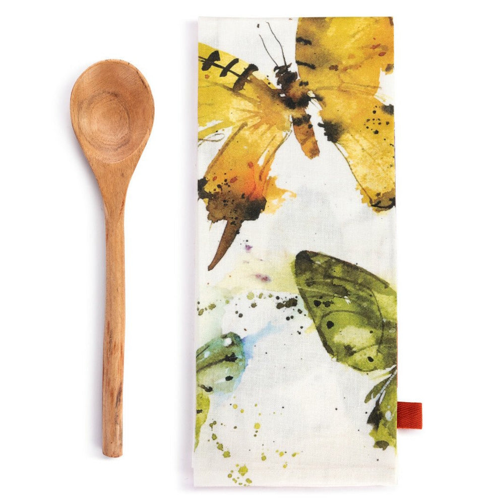 Wooden spoon next to a folded white kitchen towel featuring a watercolor butterfly print.