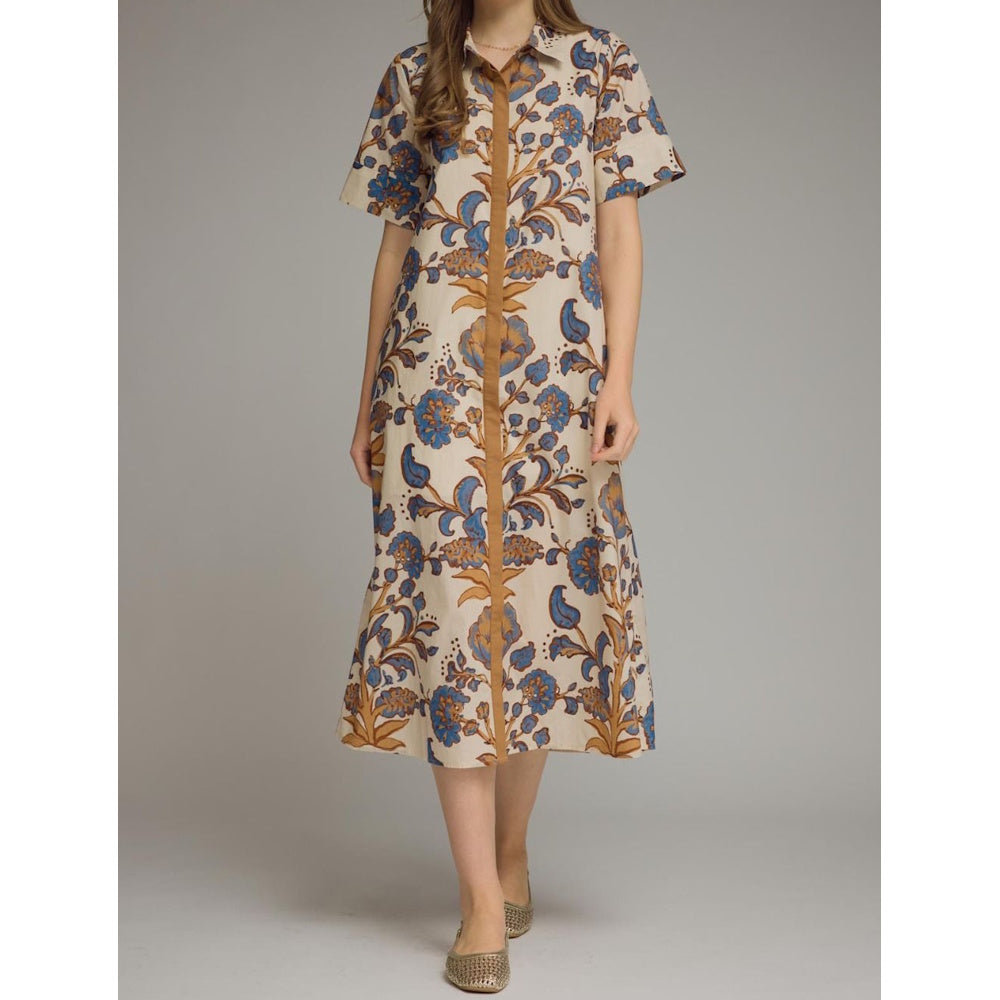 Beige midi shirt dress featuring blue and brown floral batik print with short sleeves and front button placket.