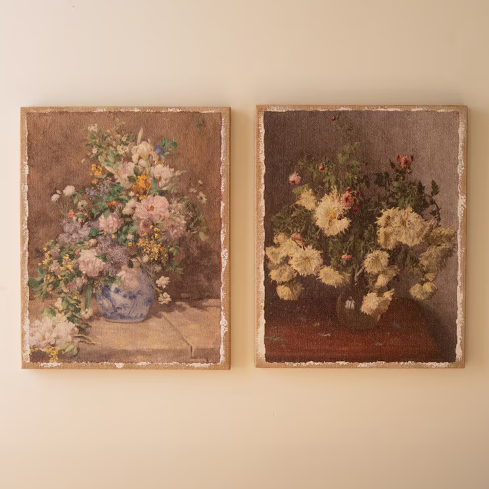 Two vintage floral burlap canvas prints with distressed borders displayed side by side on a wall.