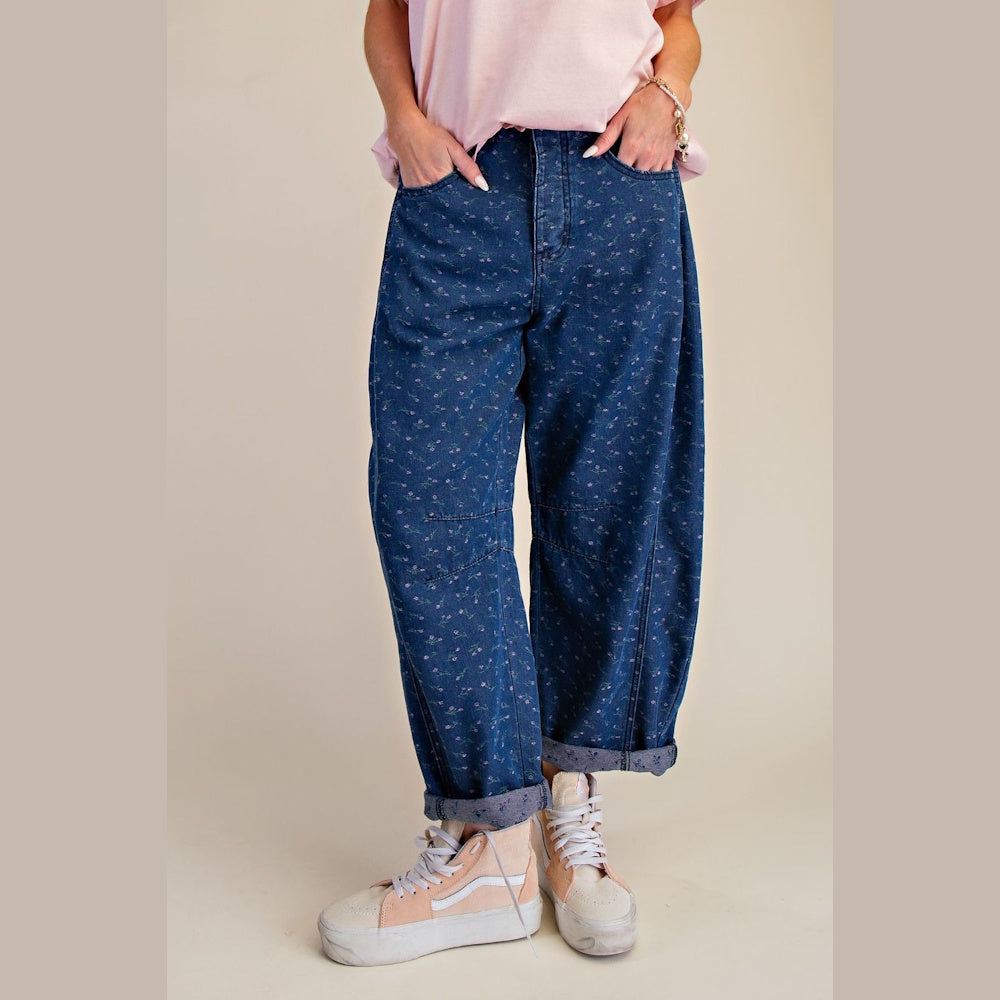 Floral printed washed barrel denim pants with cuffed hems, paired with pink and tan high-top sneakers.