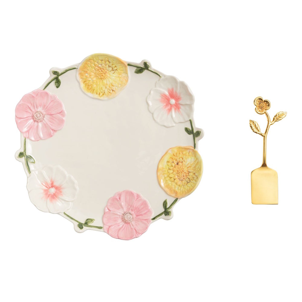 White ceramic floral platter with 3D pink and yellow flowers and a matching gold floral cake server.