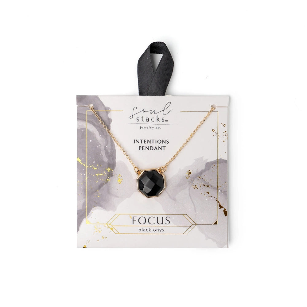 Soul Stacks black onyx Focus intentions pendant on a gold chain, displayed on a marbled white and grey jewelry card.
