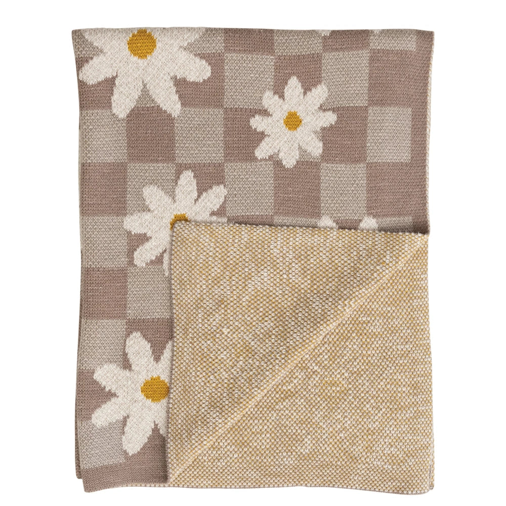 Beige and grey checkered knit blanket featuring large white daisies with yellow centers and a textured reverse side.