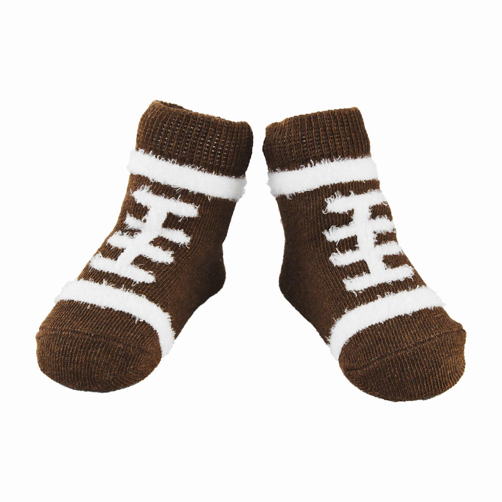 Brown fuzzy chenille socks for babies or kids featuring a white football lace pattern on a plain white background.